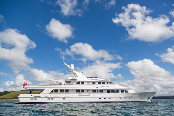 Side profile of superyacht Constance during sea trials on a clear day off the Cornish coast.