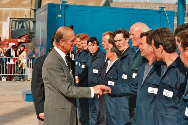 The Duke of Edinburgh shaking hands with Pendennis Shipyard staff during a formal visit.