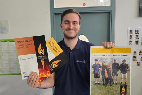 Pendennis apprentice proudly holding awards from the Apprenticeship Games 2025.