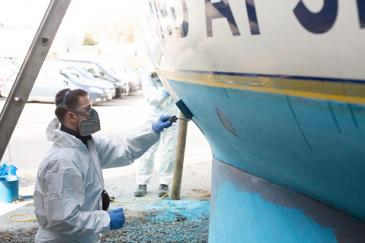 Pendennis apprentice painting the hull of S/Y Lucienne as part of Blind at Sea community project.