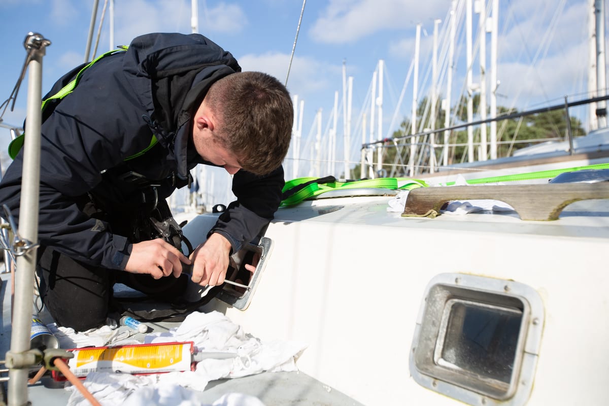 Pendennis apprentice repairing a window fitting on S/Y Lucienne during community week.
