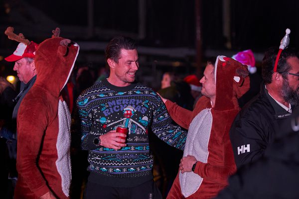 Pendennis staff and yacht crew enjoying a festive Christmas barbecue in the marina with themed outfits and holiday cheer.