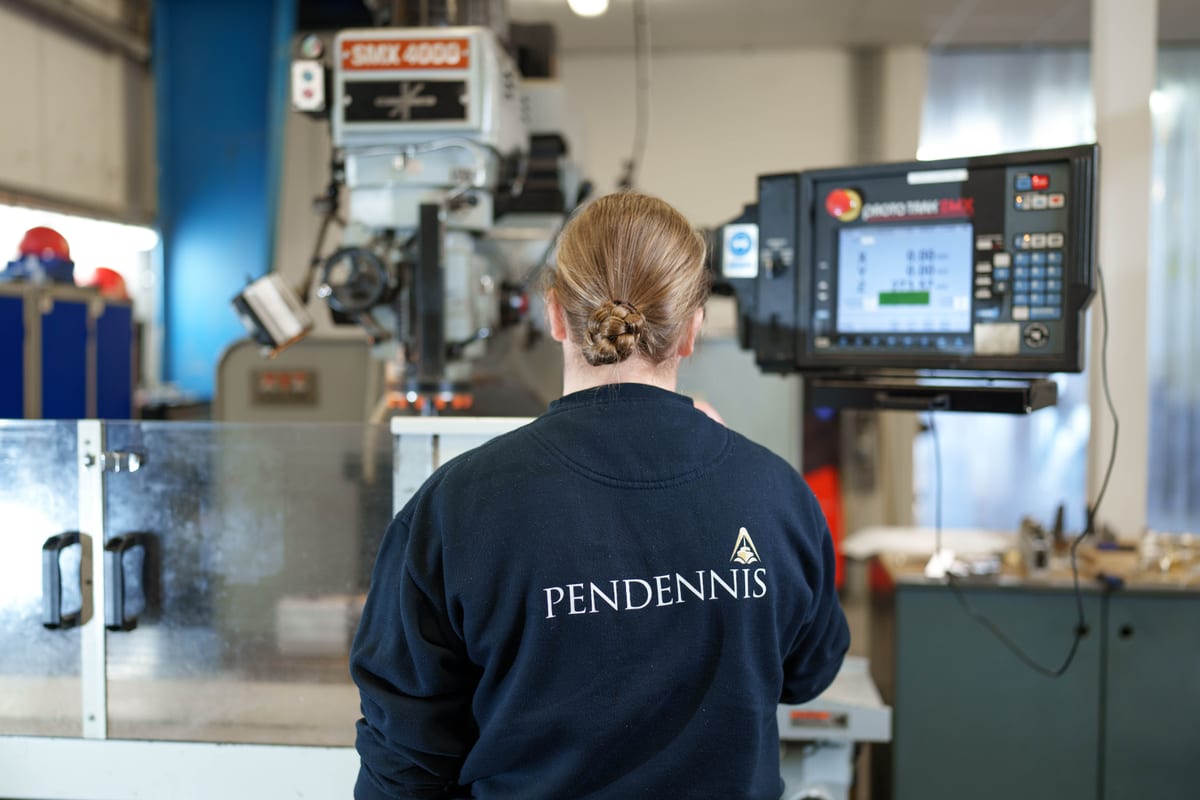Pendennis team member operating a ProtoTRAK CNC milling machine in the digital manufacturing facility.