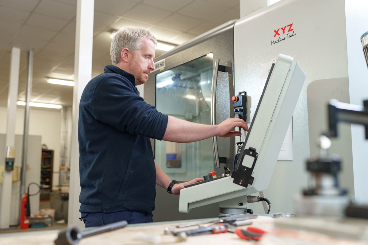 Pendennis team member programming an XYZ CNC machine in the digital manufacturing centre.