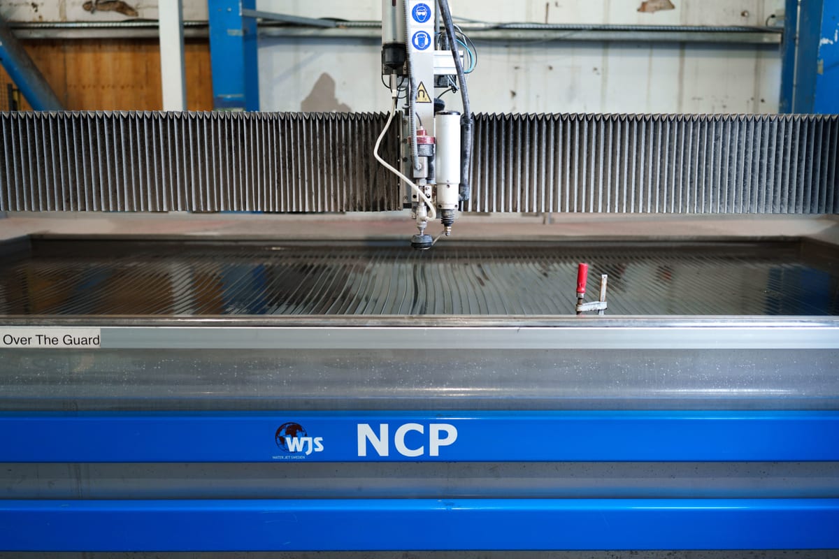 High-pressure WJS NCP waterjet cutting machine in Pendennis’s digital manufacturing facility.