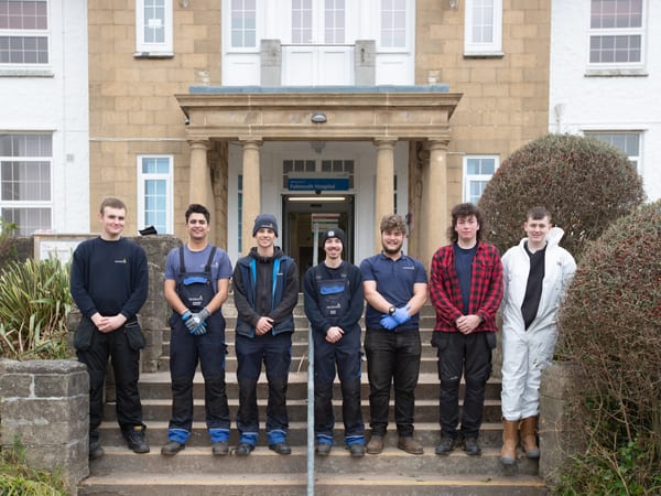 Pendennis apprentices standing outside Falmouth Hospital after taking part in community gardening during Community Week 2023.