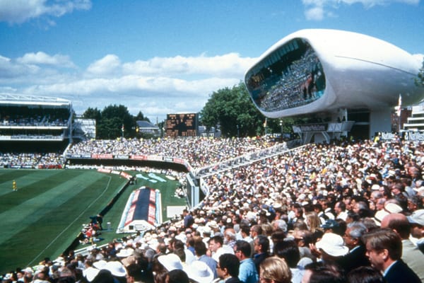 Packed crowd at Lord's Cricket Ground with the iconic media centre overlooking the pitch.