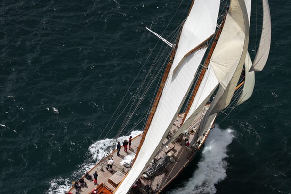 Overhead view of Mariette under full sail during the 2012 Pendennis Cup, cutting through dark blue sea.
