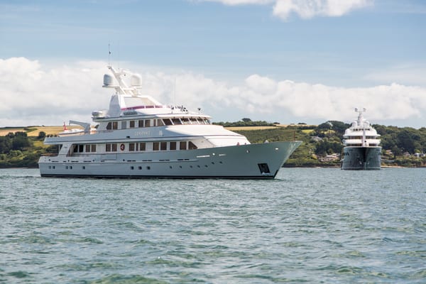 Superyachts Constance and Aquila anchored side by side in the waters off Falmouth.
