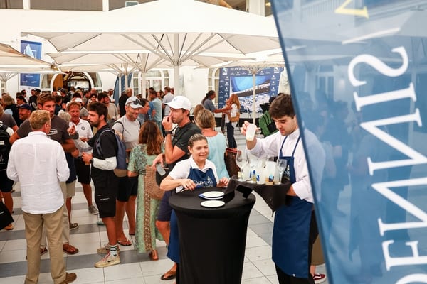 Guests enjoy drinks and conversation under umbrellas at the RCNP during Pendennis Vilanova’s Superyacht Cup Palma event.