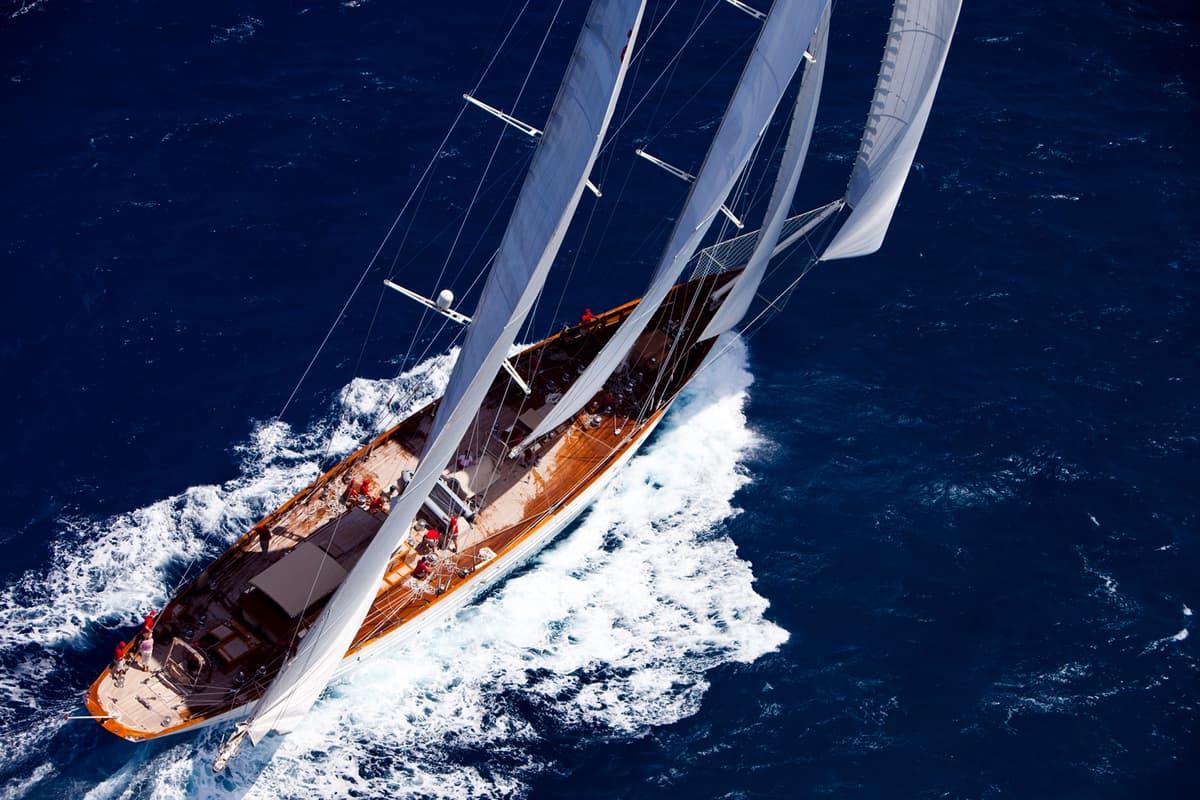 Aerial view of sailing yacht Adela racing at full speed during the 2009 St Barth’s Bucket regatta, showcasing her sleek deck layout and powerful sail plan.