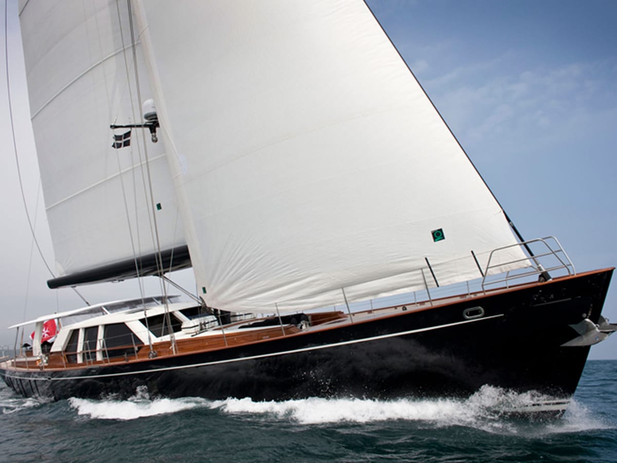 Akalam’s elegant aft deck in daylight, offering generous seating areas with polished wood details and panoramic waterfront views.