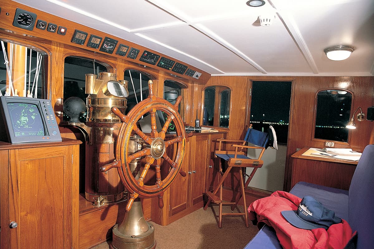 Fair Lady bridge with traditional wooden ship’s wheel and navigation equipment after 1996 refit at Pendennis.