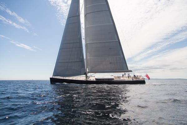 Superyacht G2 under sail during sea trials in Falmouth, with full sails set against a lightly clouded sky.