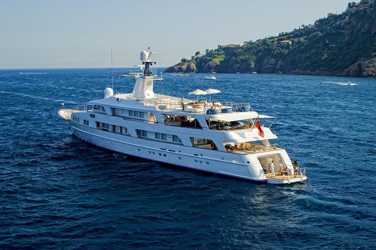 Superyacht Illusion cruising after her Pendennis refit, with guests enjoying the sun decks.