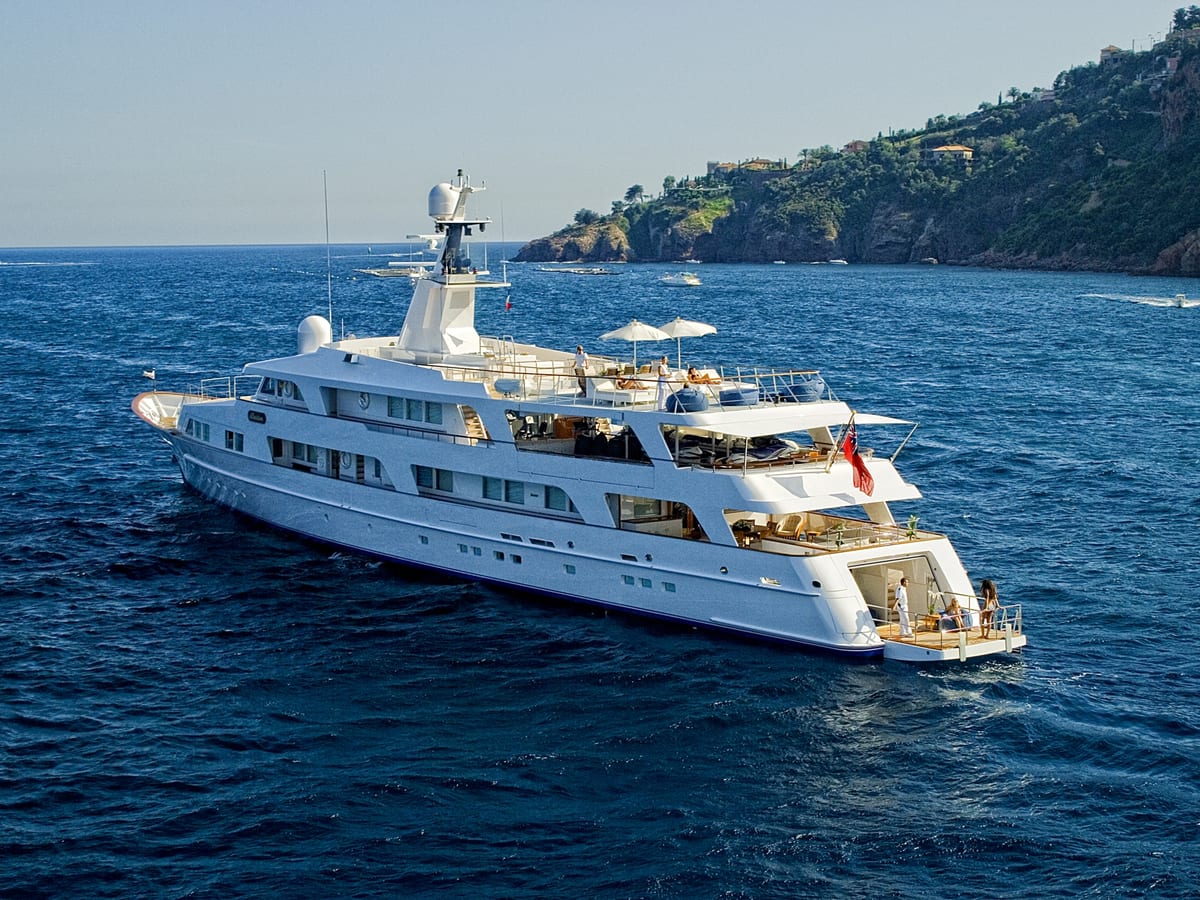Superyacht Illusion cruising after her Pendennis refit, with guests enjoying the sun decks.