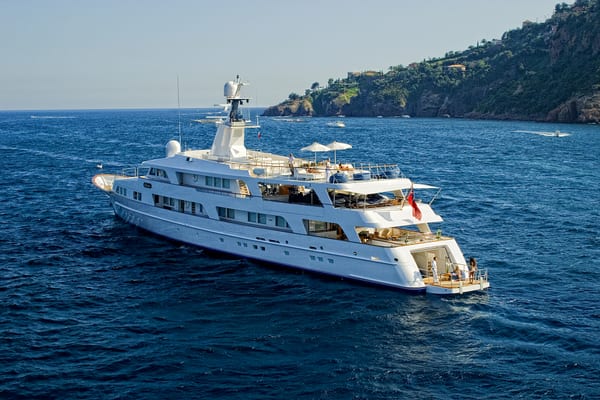 Superyacht Illusion cruising after her Pendennis refit, with guests enjoying the sun decks.