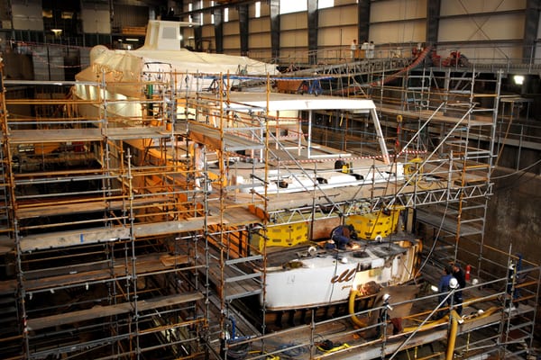 Scaffolding surrounds Illusion's stern as refit works begin to remove the aft section.