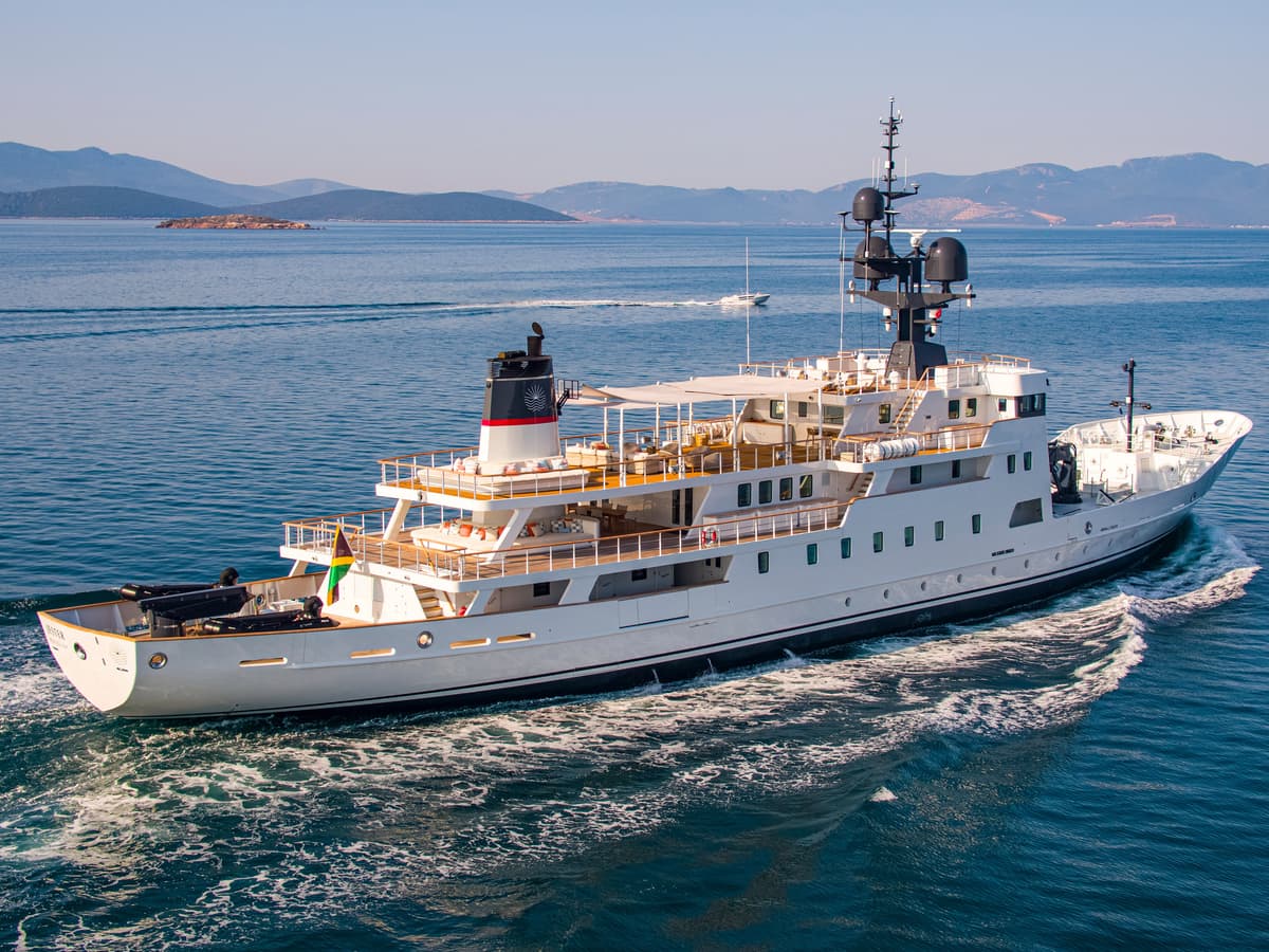 Motor yacht Jester cruising at sea, showing her refreshed exterior design following an extensive refit.