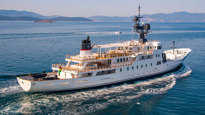 Motor yacht Jester cruising at sea, showing her refreshed exterior design following an extensive refit.