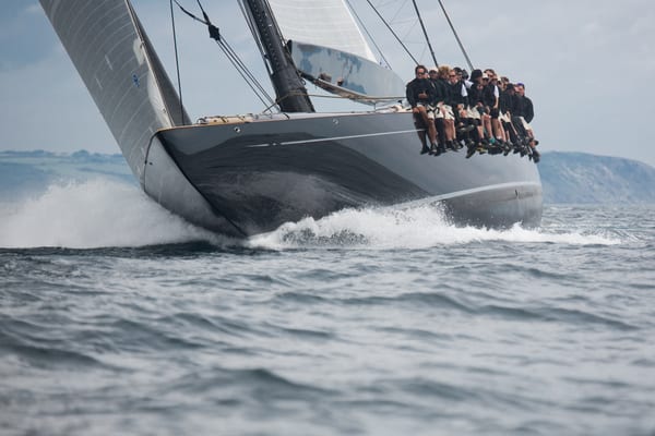 J Class yacht Lionheart powering through waves with crew hiking out during the 2015 Regatta in Falmouth.