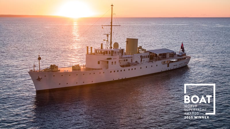 Superyacht Marala at sunset after her Pendennis restoration, with BOAT International 2023 World Superyacht Award winner badge.
