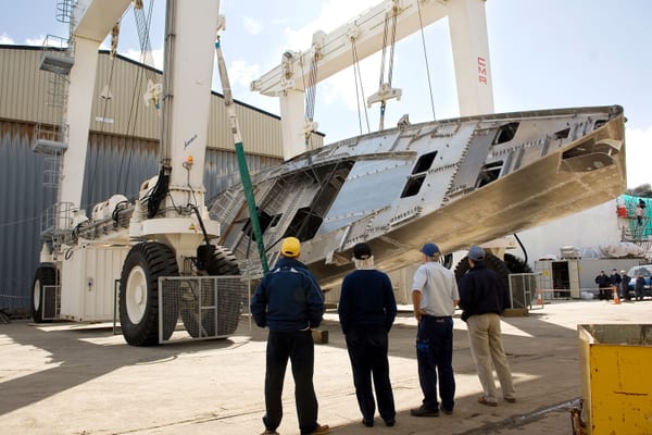 Nostromo’s aluminium hull being turned by a travel hoist during construction at Pendennis in 2009.