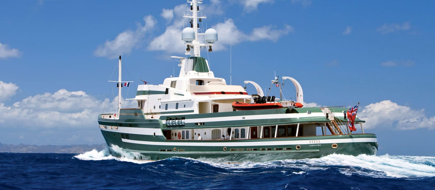 Explorer yacht STEEL cruising through open water under clear skies.