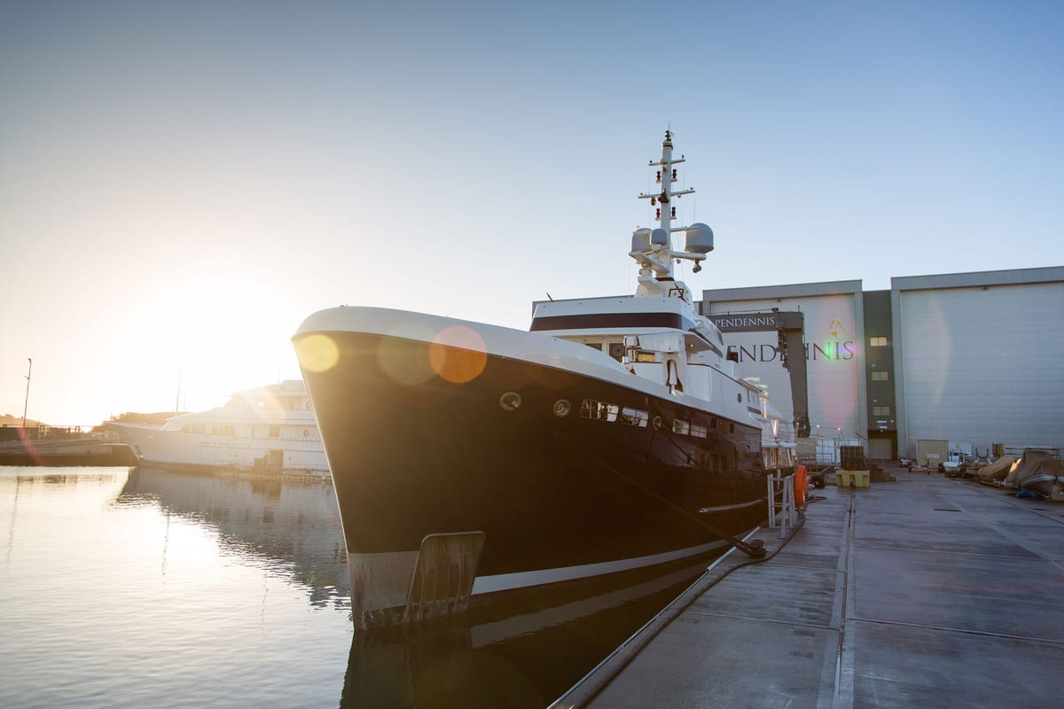 Explorer yacht STEEL docked at Pendennis in 2017 after her repaint, with sunset light on the water.