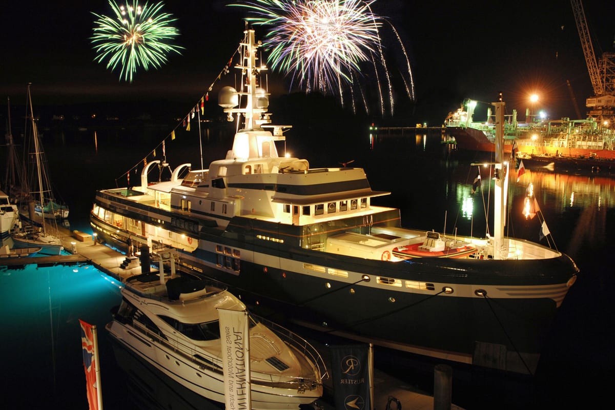 Explorer yacht STEEL lit up at night during her 2009 launch at the National Maritime Museum in Falmouth, with fireworks overhead.