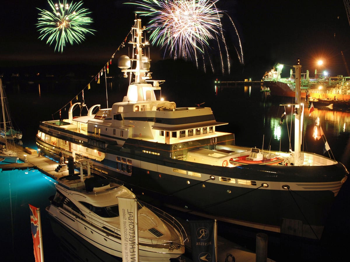 Explorer yacht STEEL lit up at night during her 2009 launch at the National Maritime Museum in Falmouth, with fireworks overhead.