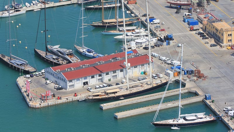 Aerial view of Pendennis Palma refit office surrounded by sailing yachts and superyachts moored in the marina.