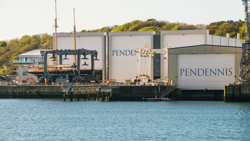 Classic sailing yacht in a mobile hoist at Pendennis Shipyard following the completion of Phase 1 yard development.