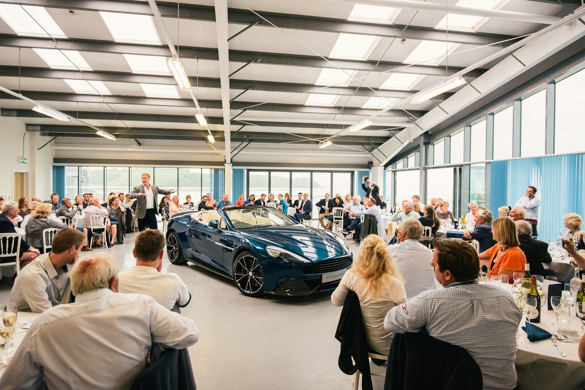 Guests gather around an Aston Martin in Pendennis' hospitality suite