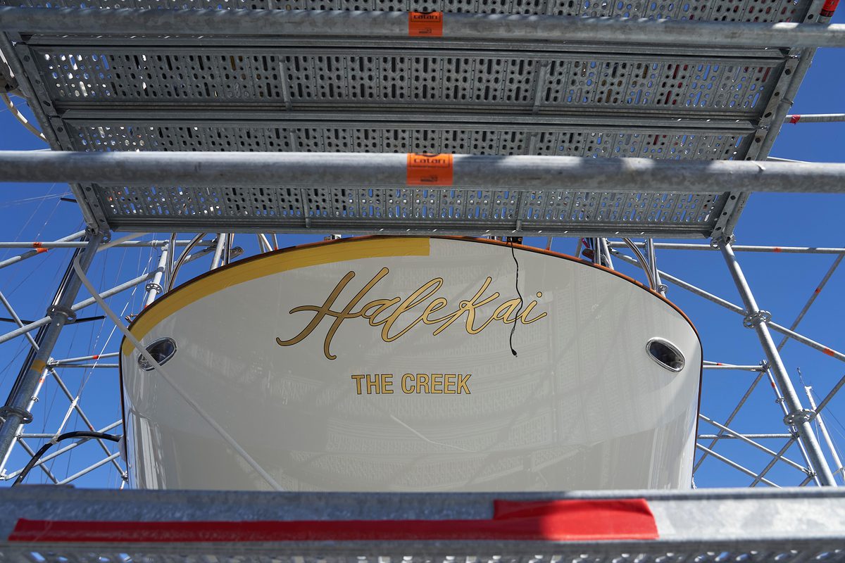 Stern view of Halekai with name and hailing port ‘The Creek’ visible, surrounded by scaffolding during refit.