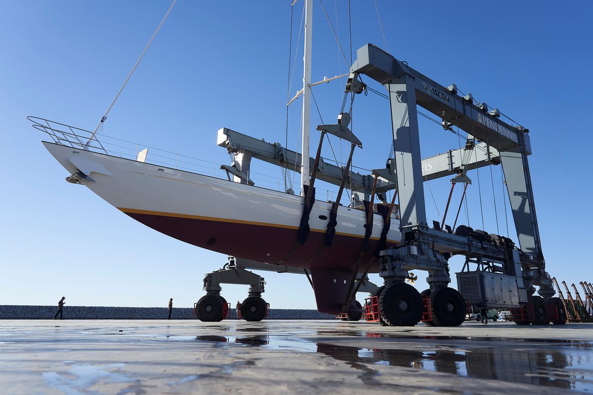 Classic sailing yacht Halekai being moved by hoist at Pendennis Vilanova during refit works.