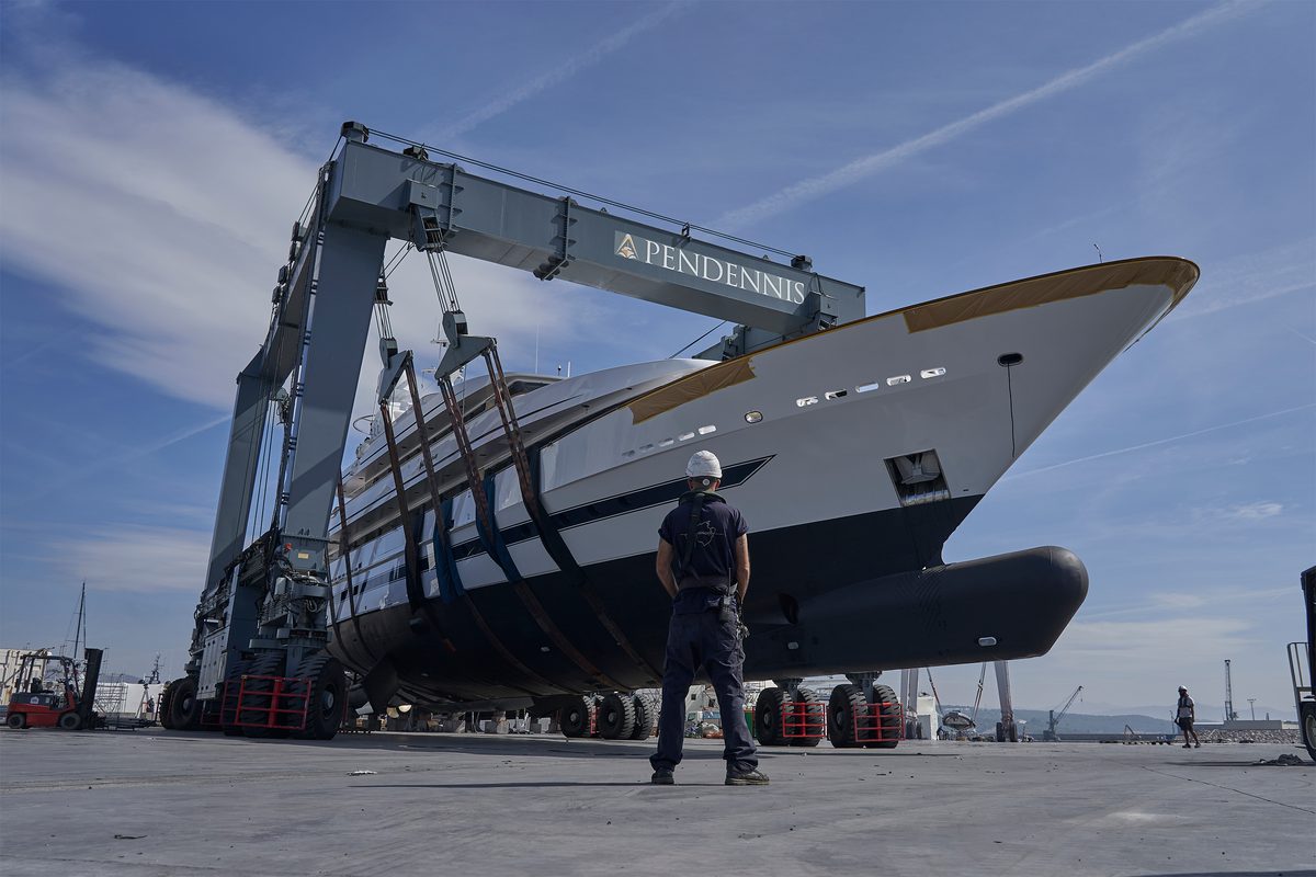 A motor yacht being lifted in a travel hoist