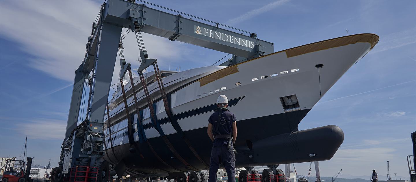 A motor yacht being lifted in a travel hoist