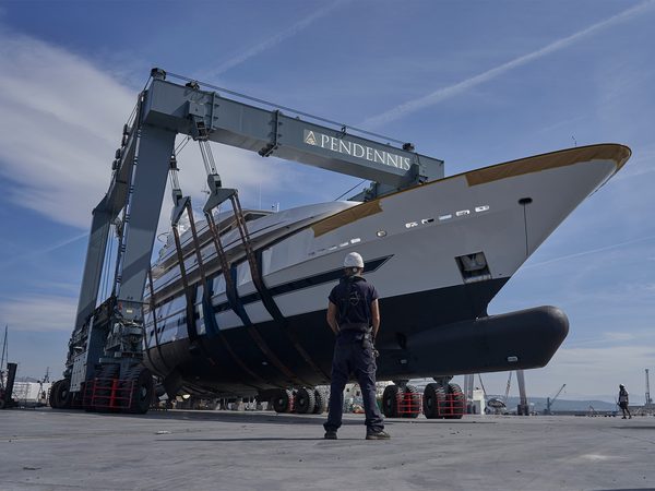 A motor yacht being lifted in a travel hoist