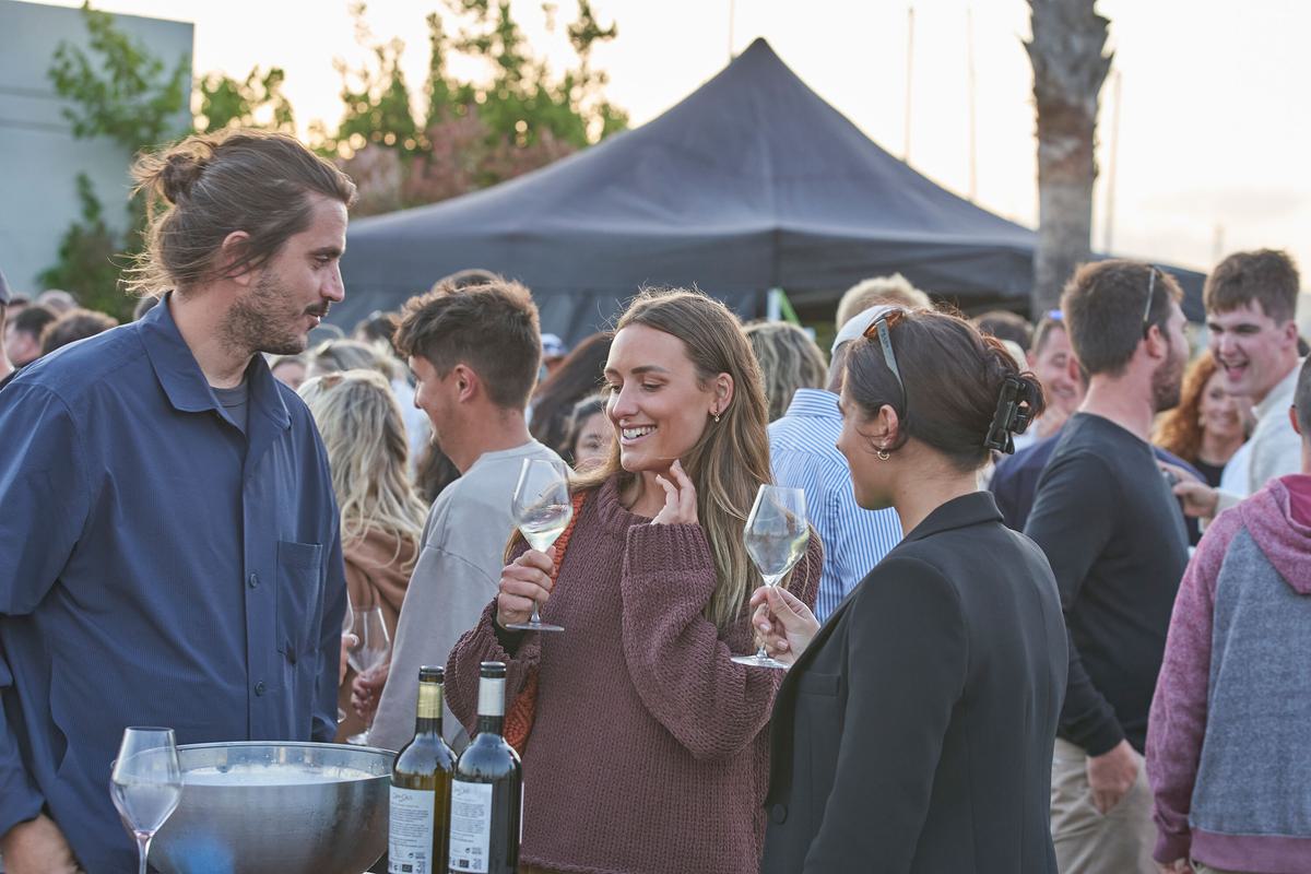 Yacht crew enjoying wine tasting evening in marina