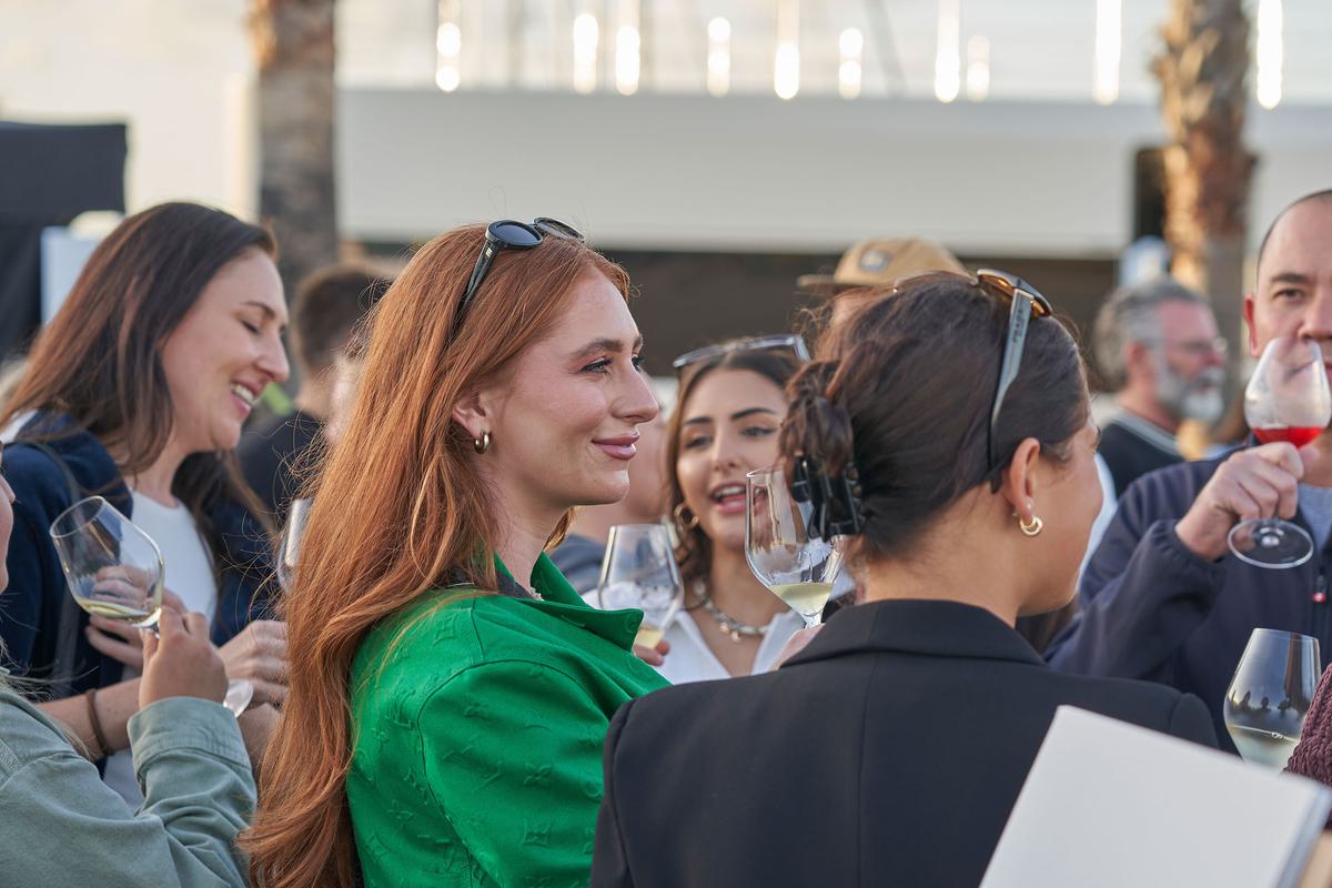 A group of people holding glasses of wine