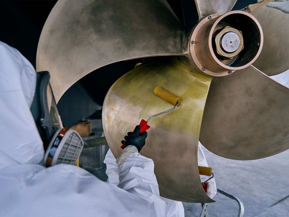 Pendennis technician applying protective coating to a superyacht propeller at Vilanova facility near Barcelona.