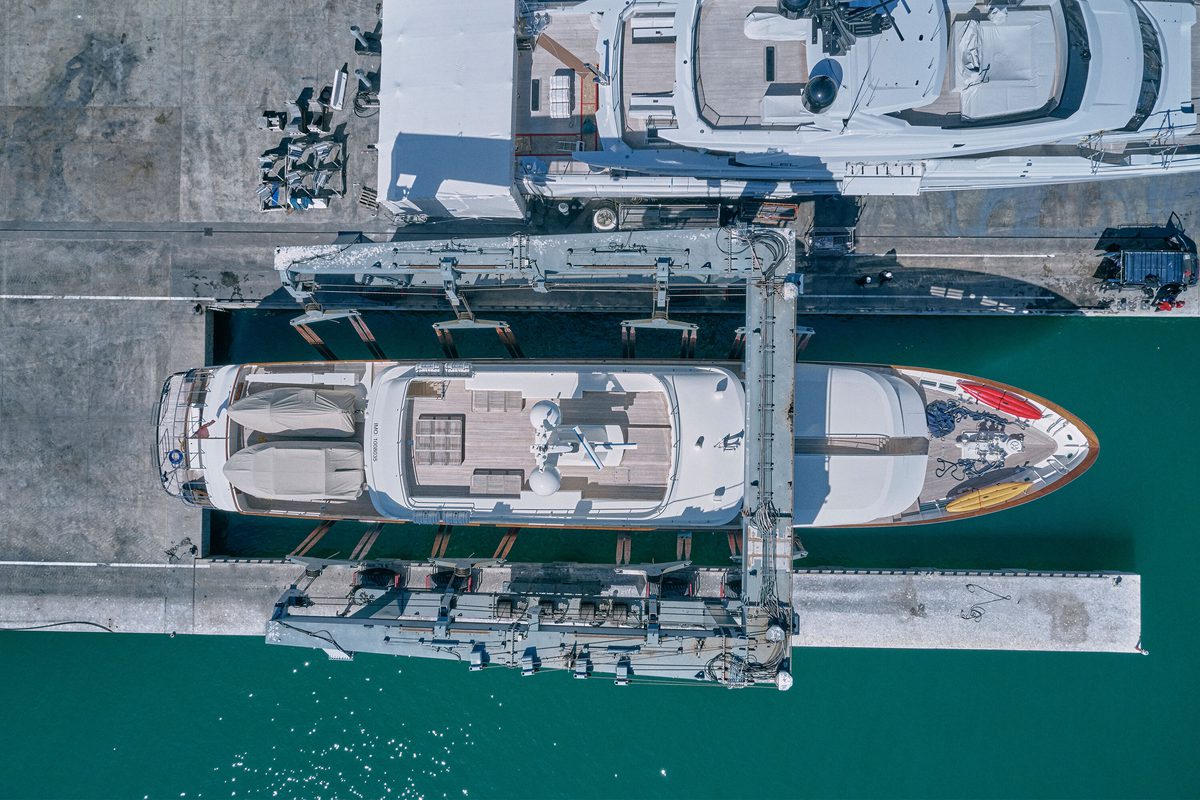 Aerial view of a superyacht lifted by the Pendennis travel hoist at Vilanova Technical Service Centre.