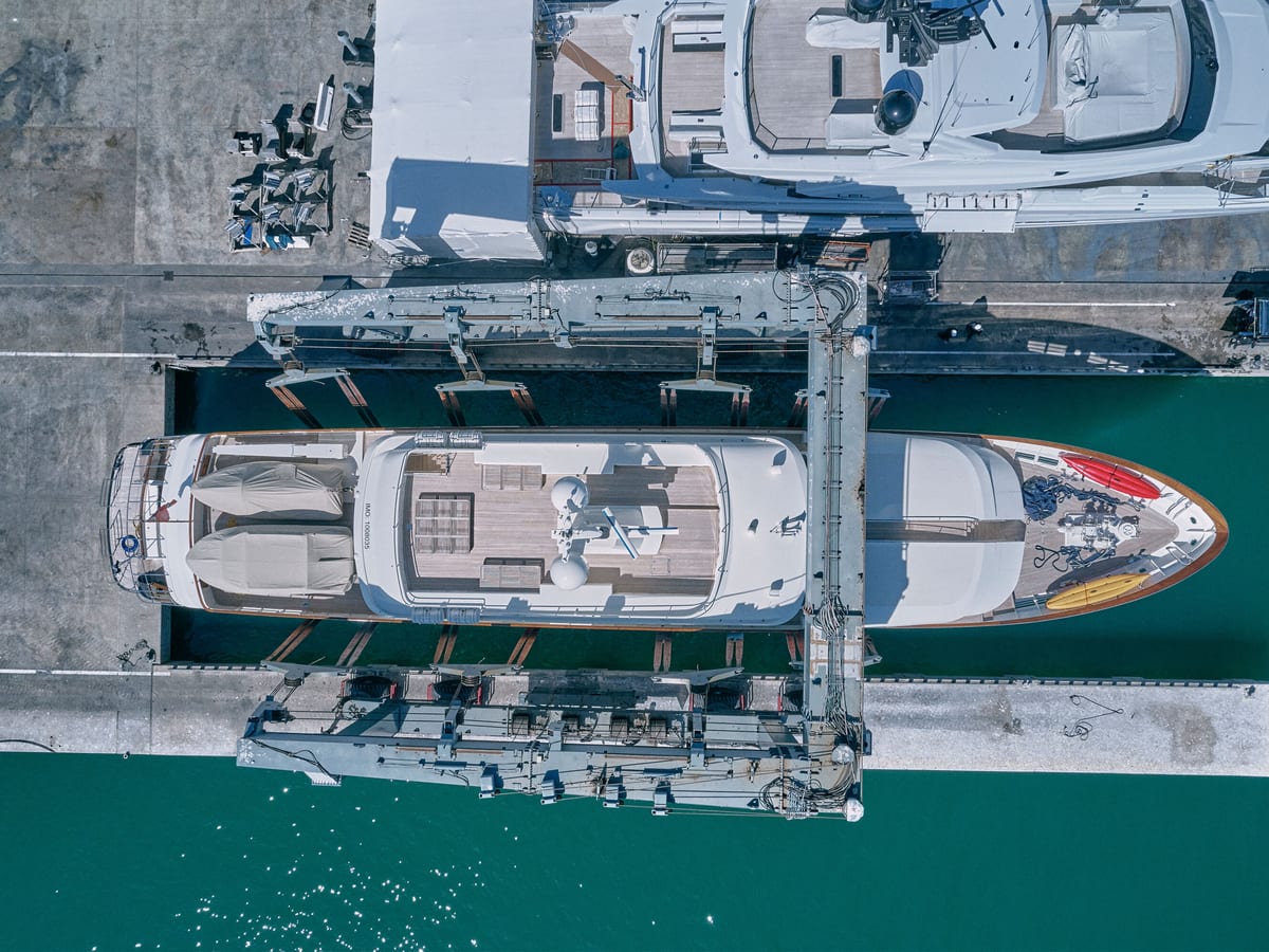 Aerial view of a superyacht lifted by the Pendennis travel hoist at Vilanova Technical Service Centre.